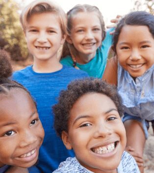 A group of children smiling for the camera.