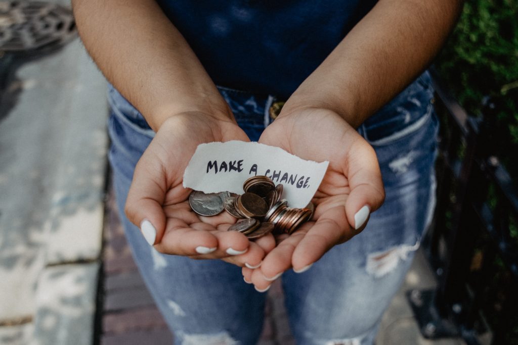 A person holding some coins in their hands