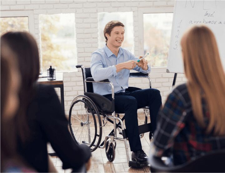 A man in a wheelchair is holding something