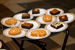 A table with plates of different types of desserts.